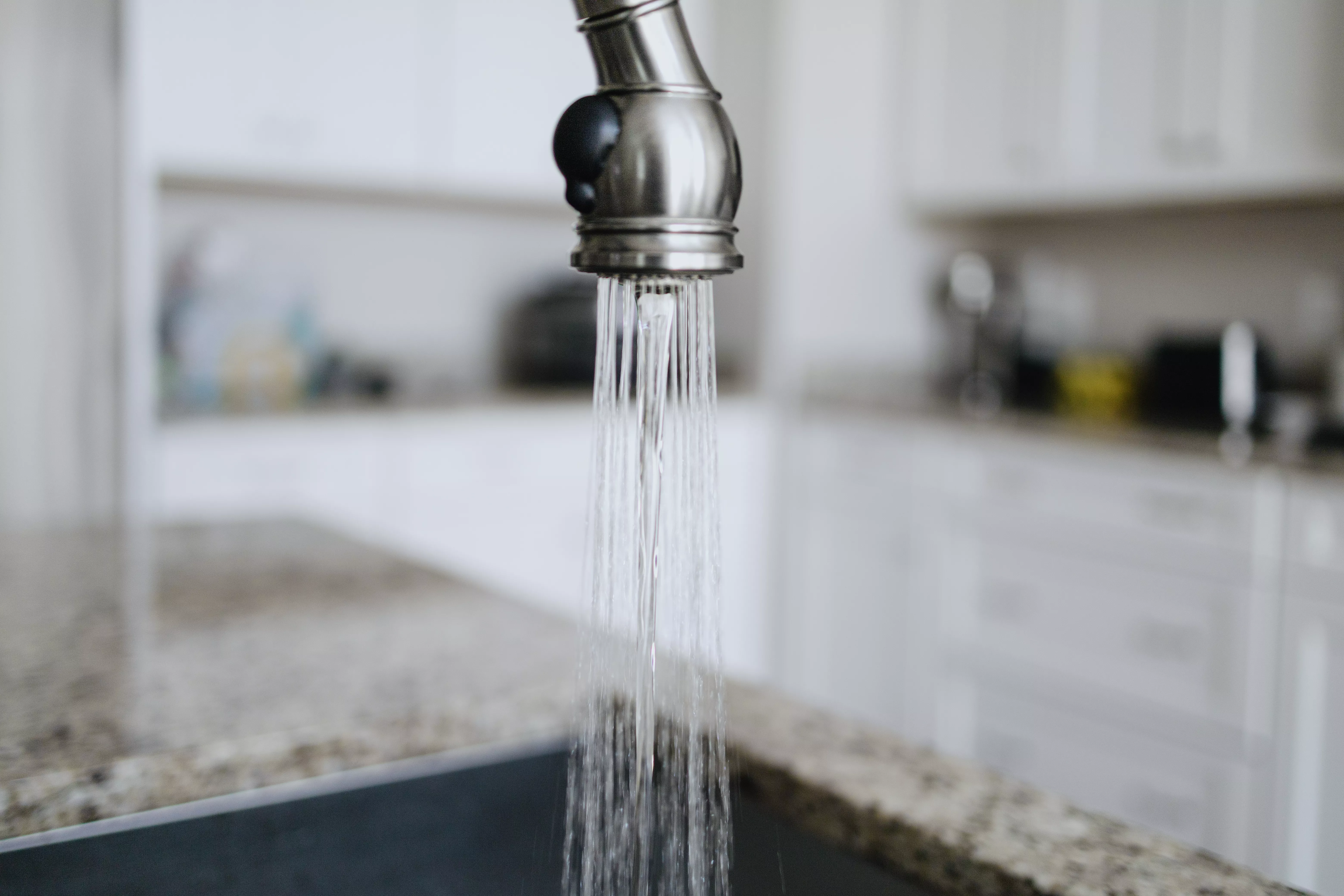 Close-up of water flowing from kitchen faucet