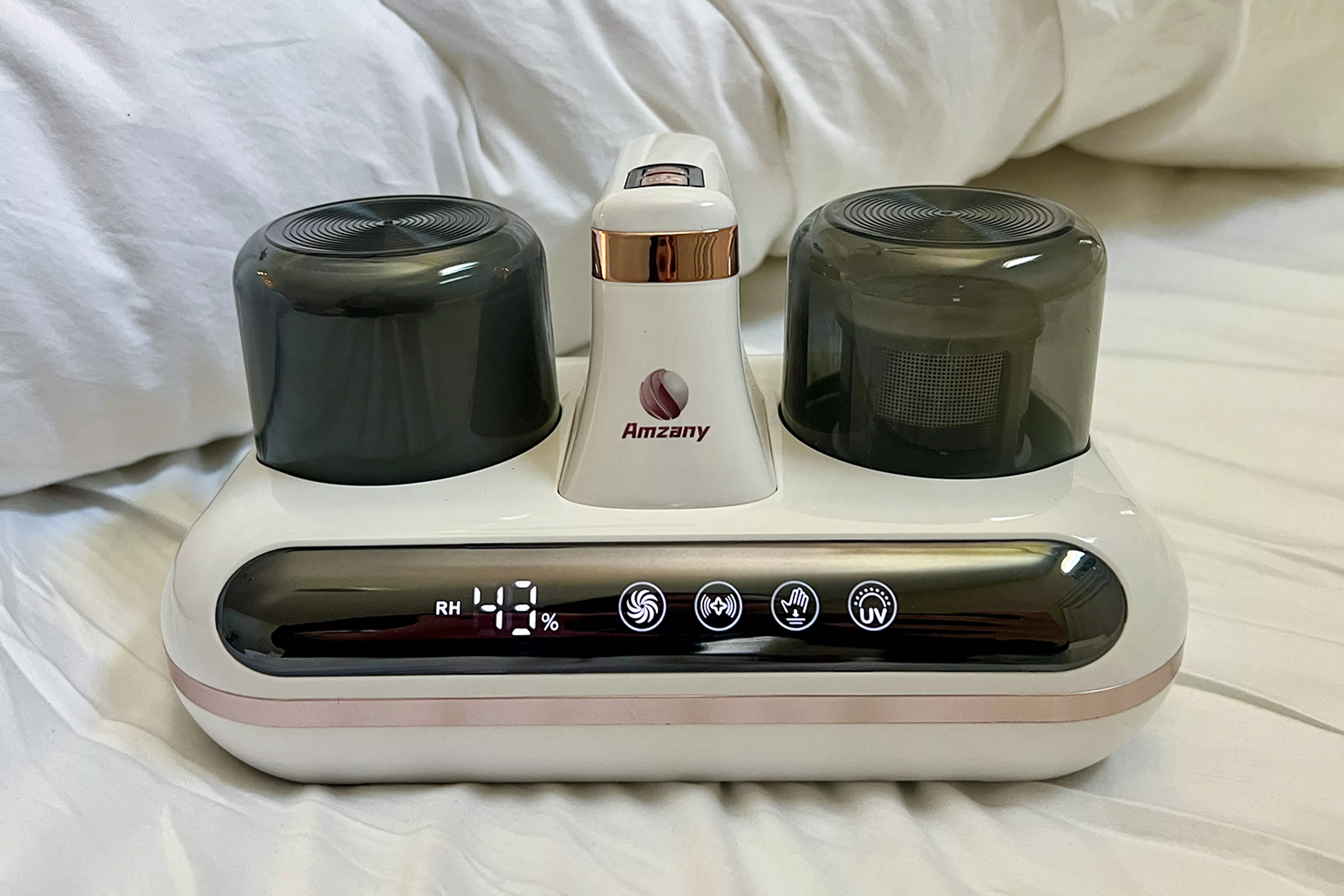 A household vacuum cleaner device placed on a bed