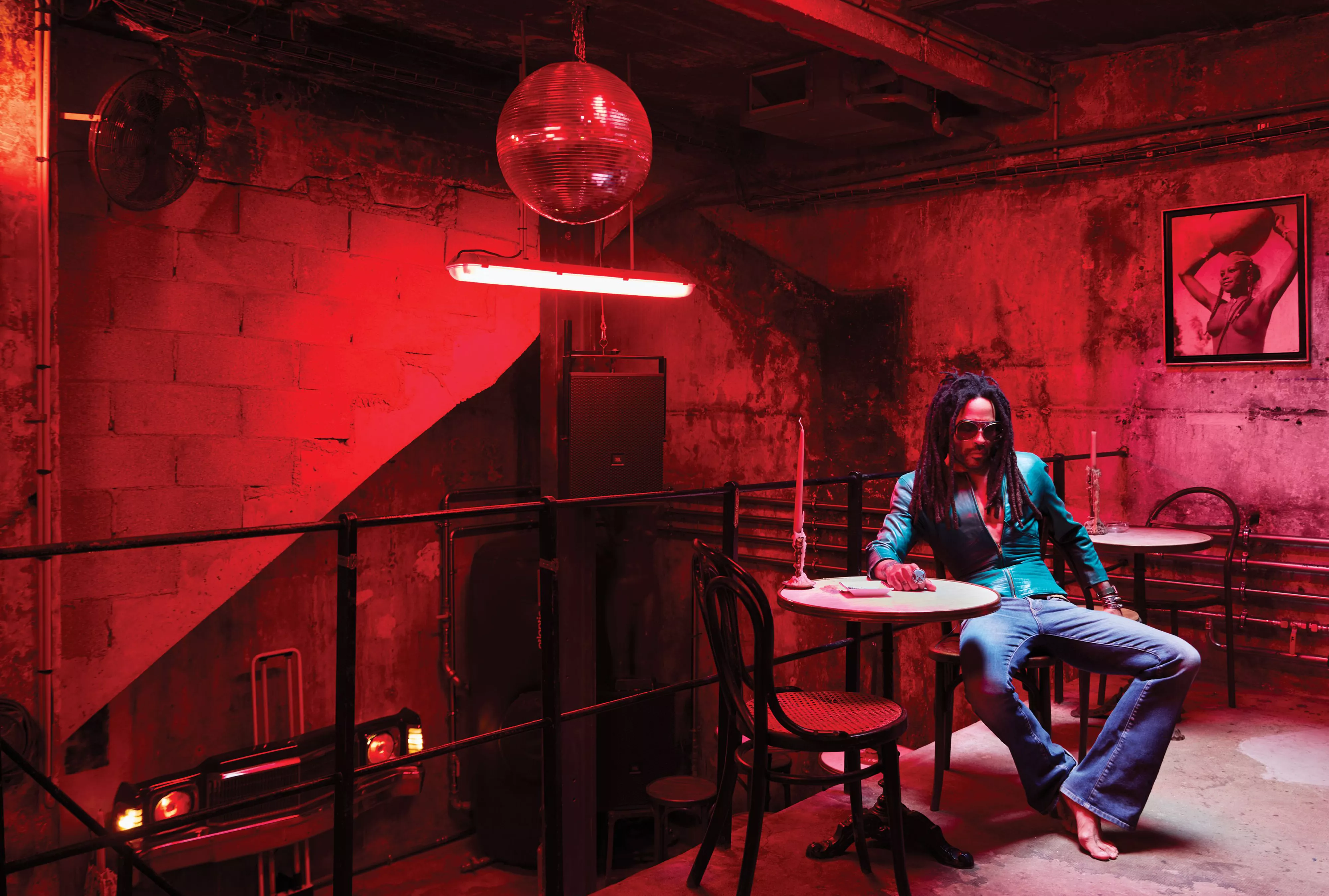 Lenny Kravitz sitting at a table in his basement club