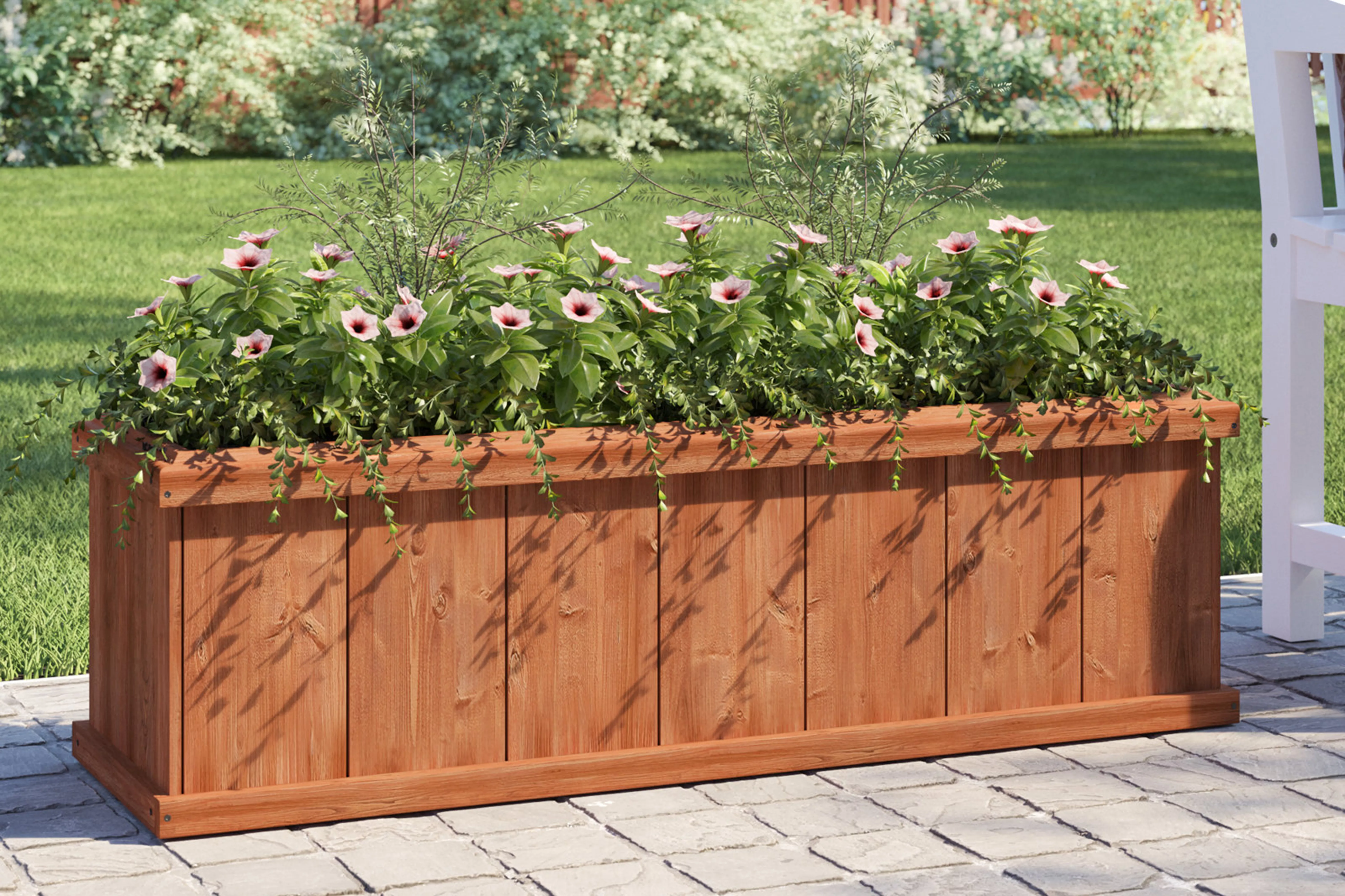 Barros Outdoor Wood Planter Box filled with pink flowers on an outside patio